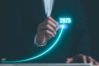 Businessman using pen drawing line for increasing arrow from 2024 to 2025