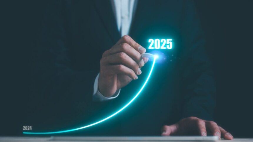 Businessman using pen drawing line for increasing arrow from 2024 to 2025